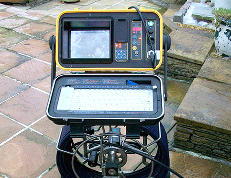 A CCTV drain camera control unit set up on a patio