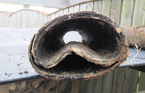 The end of a deformed pitch fibre pipe, squashed almost flat
