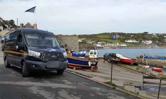 The navy van at a harbour slipway with fishing boats